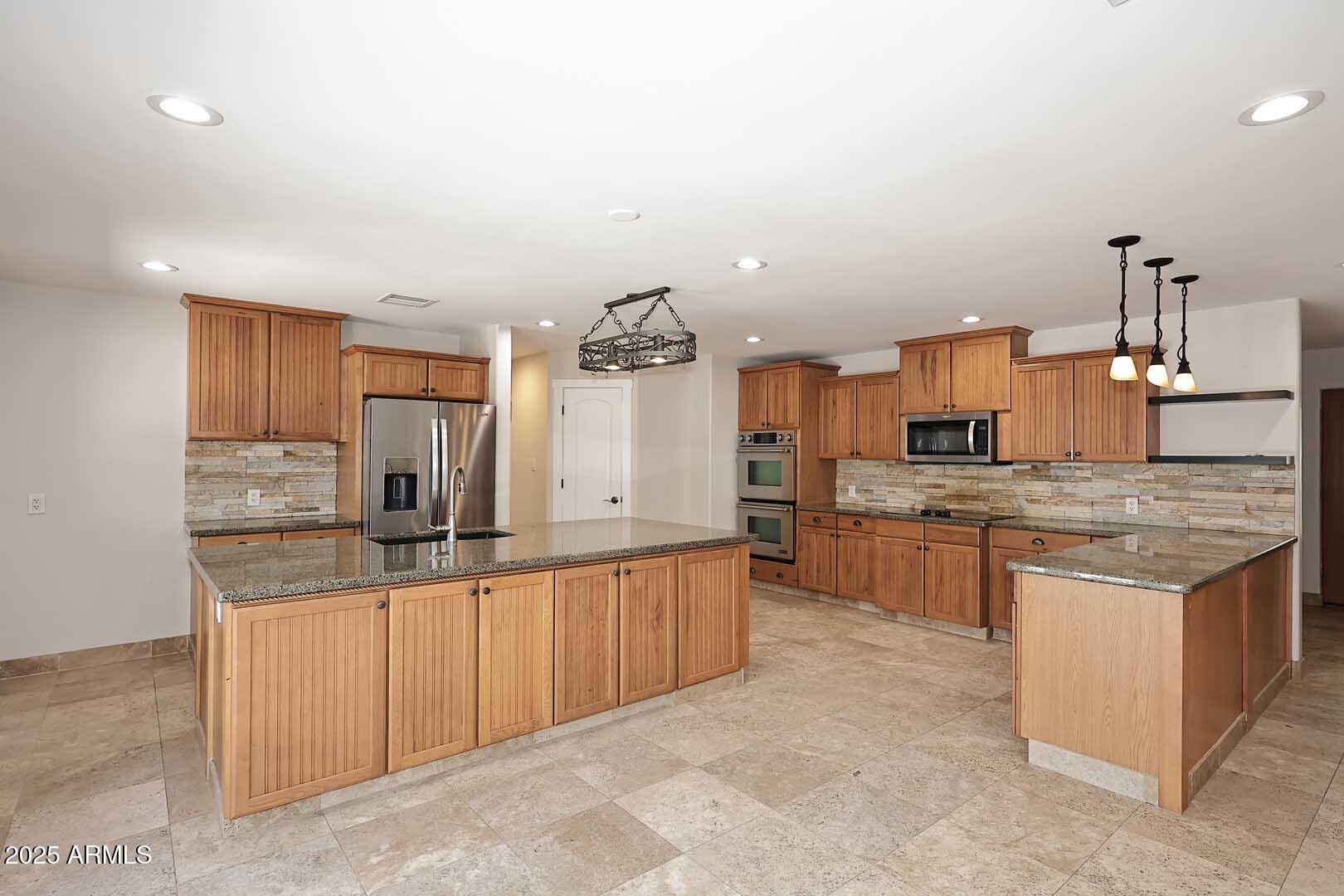 5449 East Thunderbird Road Scottsdale, AZ 85254 - Photo 18 of 75 a kitchen with stainless steel appliances granite countertop a sink and cabinets