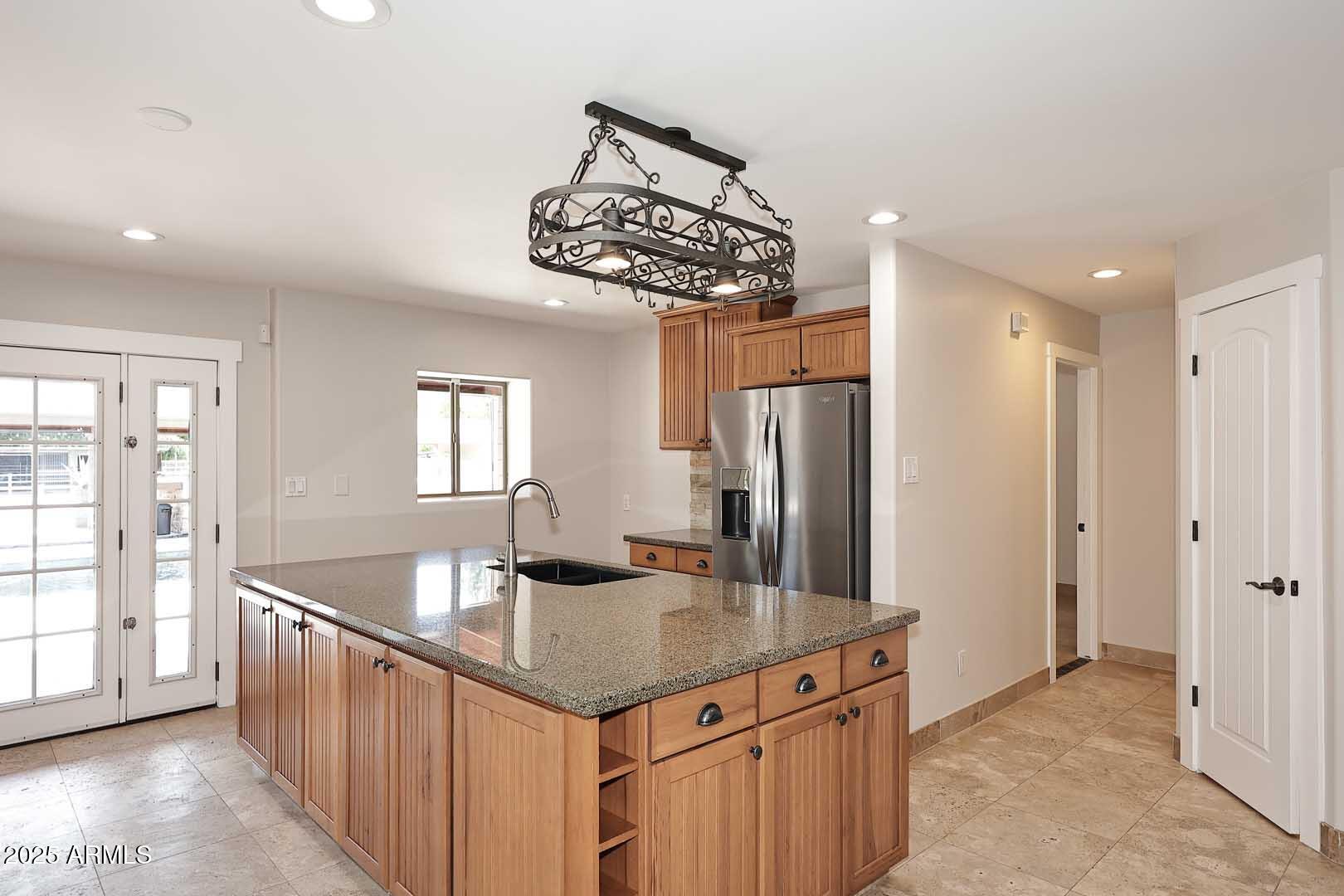 5449 East Thunderbird Road Scottsdale, AZ 85254 - Photo 19 of 75 a kitchen with stainless steel appliances granite countertop a sink a refrigerator and a stove