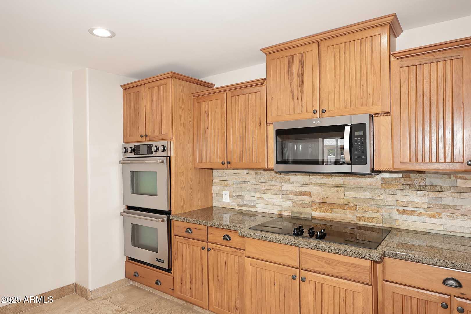 5449 East Thunderbird Road Scottsdale, AZ 85254 - Photo 20 of 75 a kitchen with granite countertop a sink stove and microwave