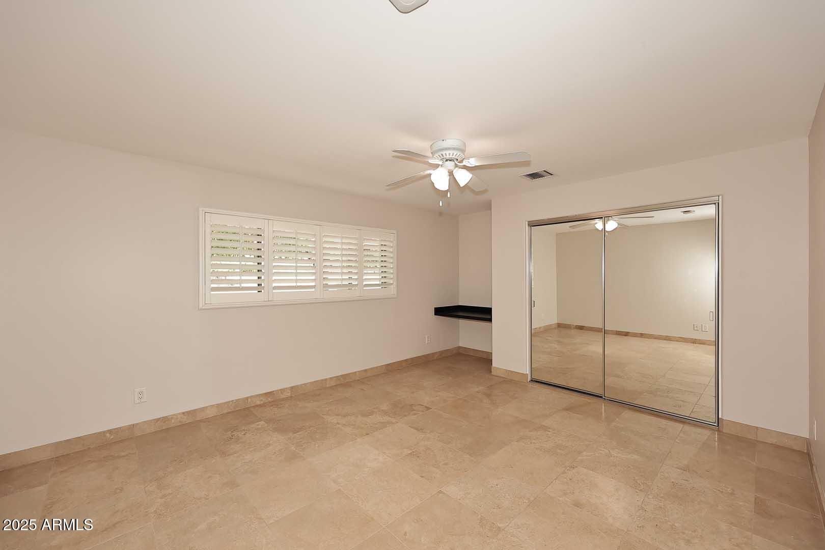 5449 East Thunderbird Road Scottsdale, AZ 85254 - Photo 27 of 75 an empty room with chandelier fan and windows