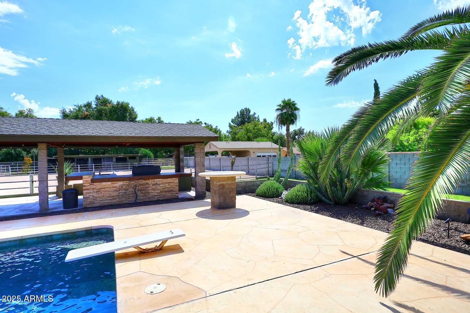 5449 East Thunderbird Road Scottsdale, AZ 85254 - Photo 49 of 75 a view of a swimming pool with a patio
