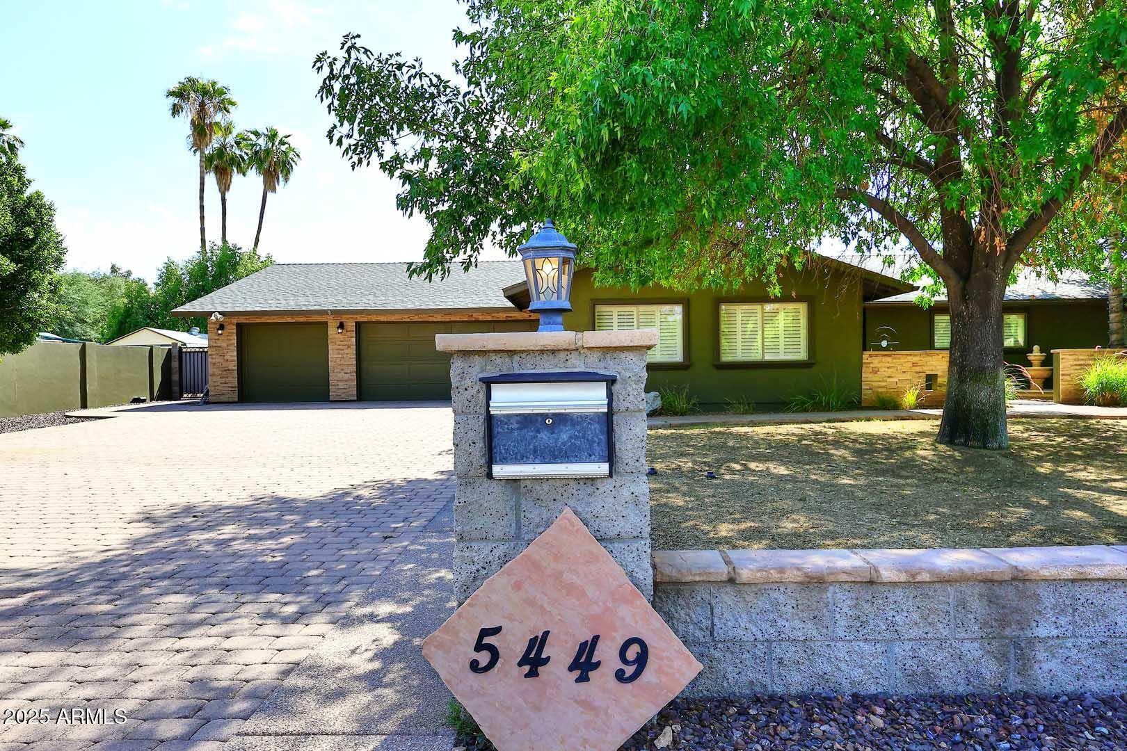 5449 East Thunderbird Road Scottsdale, AZ 85254 - Photo 6 of 75 a front view of a house with a yard and garage