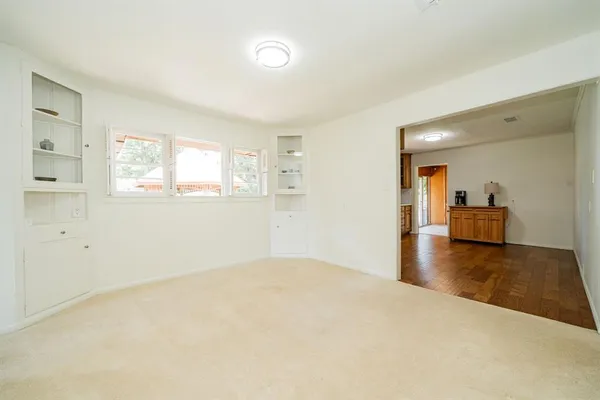 a view of a livingroom with wooden floor and a window