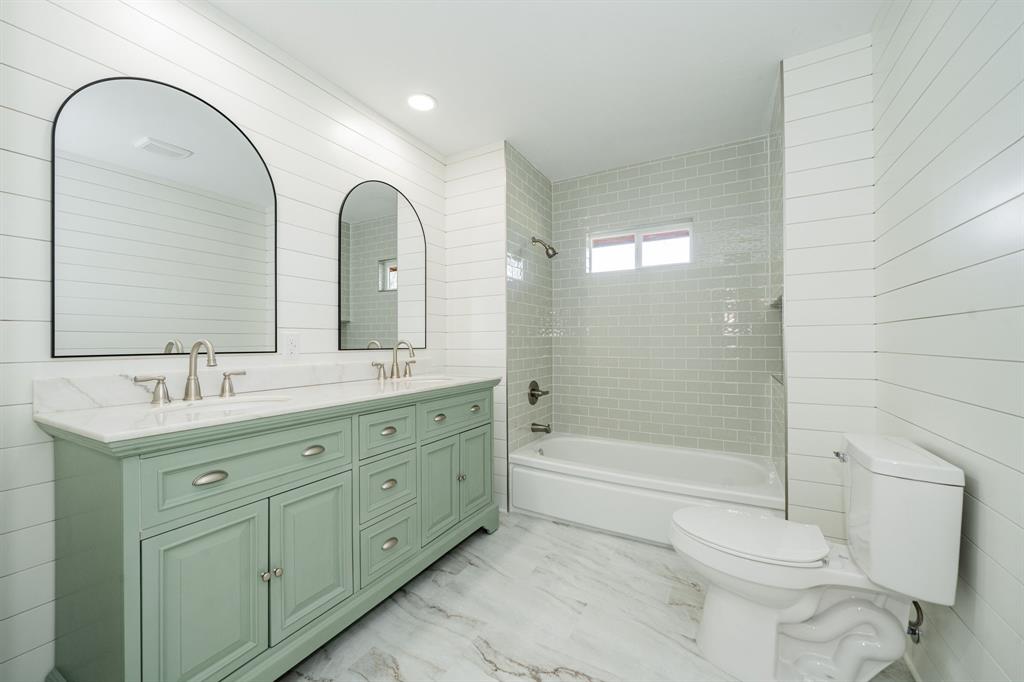 809 Cobb Street Bridgeport, TX 76426 - Photo 15 of 39 a bathroom with a double vanity sink toilet and shower