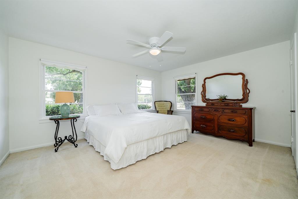 809 Cobb Street Bridgeport, TX 76426 - Photo 18 of 39 a spacious bedroom with a bed and a chandelier