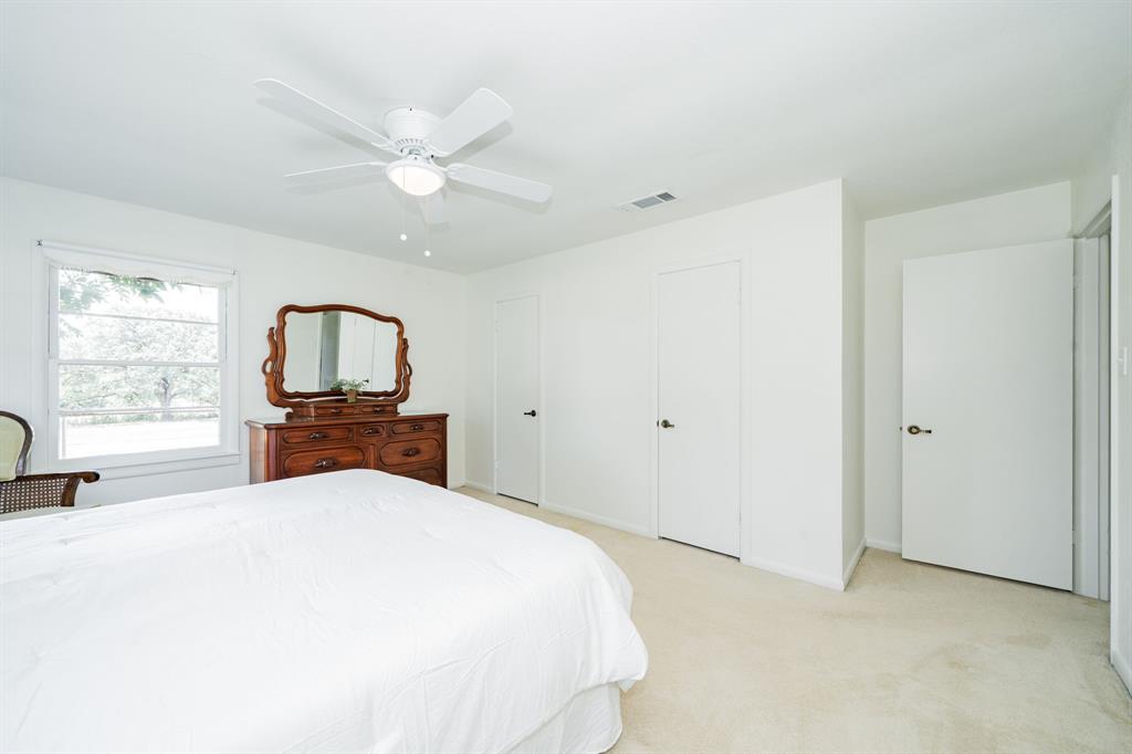 809 Cobb Street Bridgeport, TX 76426 - Photo 19 of 39 a bedroom with a bed and a tv on the dresser