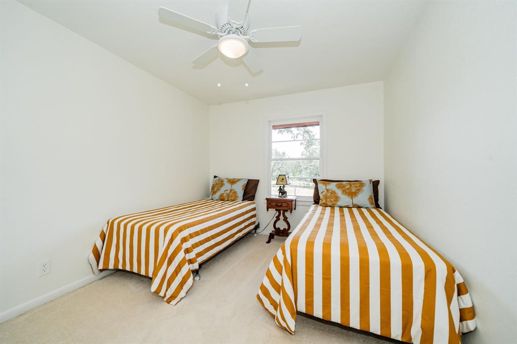 809 Cobb Street Bridgeport, TX 76426 - Photo 20 of 39 a bedroom with two beds and a chandelier