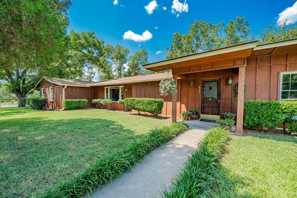 809 Cobb Street Bridgeport, TX 76426 - Photo 2 of 39 a front view of house with a garden