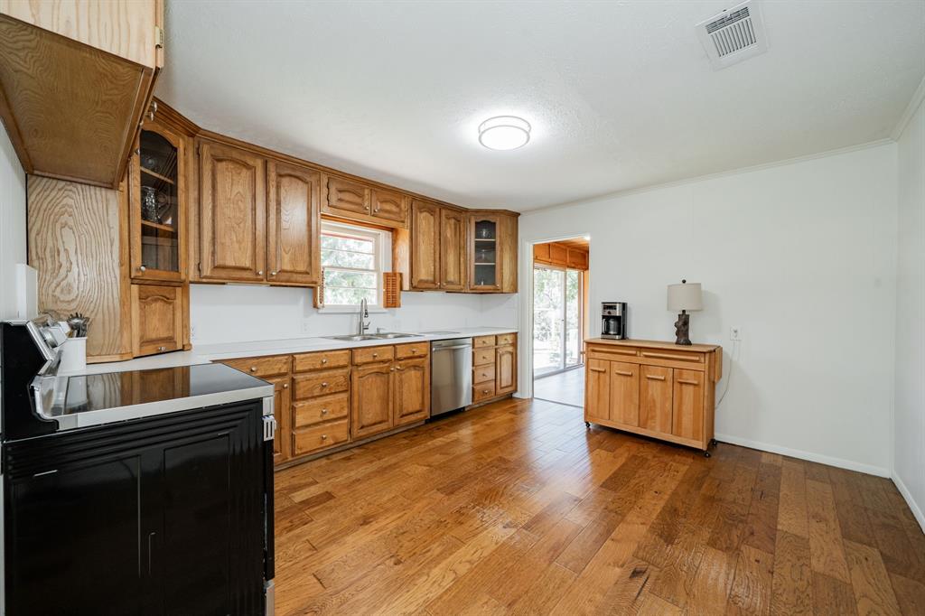 809 Cobb Street Bridgeport, TX 76426 - Photo 24 of 39 a kitchen with stainless steel appliances granite countertop a sink a stove counter space and cabinets