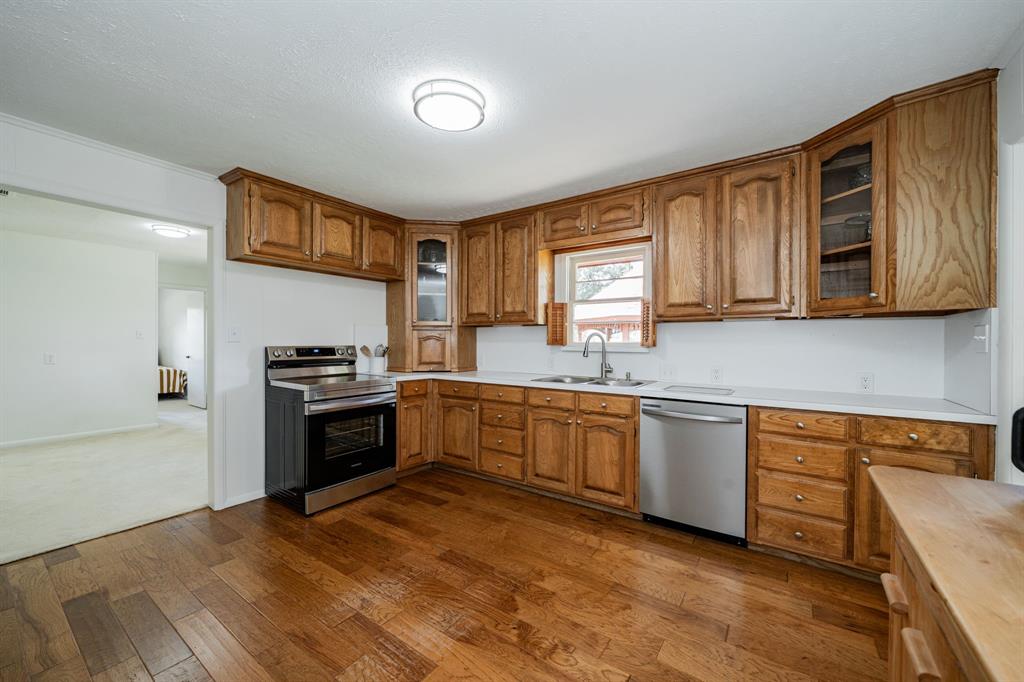 809 Cobb Street Bridgeport, TX 76426 - Photo 25 of 39 a kitchen with granite countertop a refrigerator stove top oven and sink