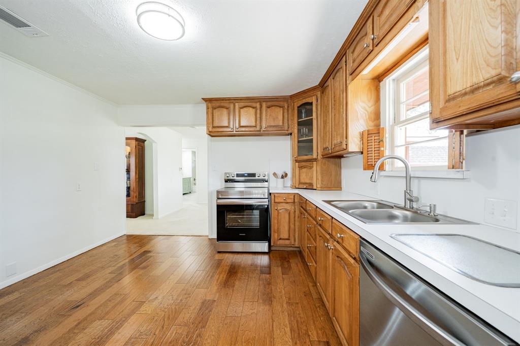 809 Cobb Street Bridgeport, TX 76426 - Photo 26 of 39 a kitchen with granite countertop a stove a sink and a wooden floors