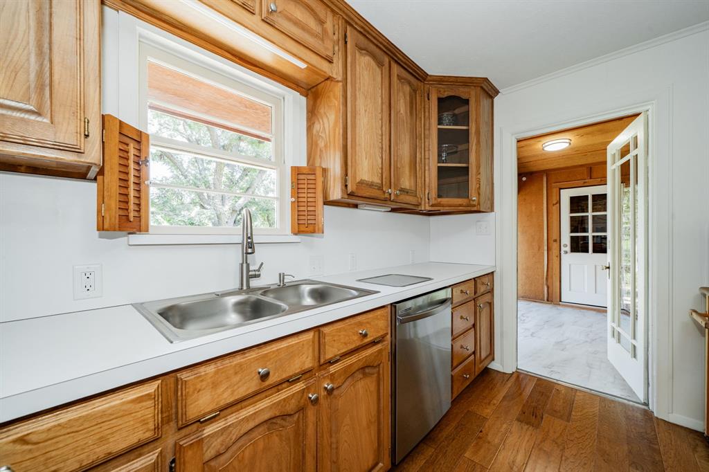 809 Cobb Street Bridgeport, TX 76426 - Photo 27 of 39 a kitchen with stainless steel appliances granite countertop a sink a stove and a wooden cabinets