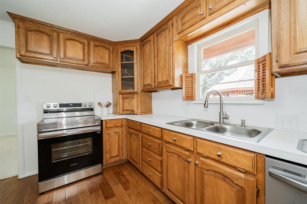 809 Cobb Street Bridgeport, TX 76426 - Photo 28 of 39 a kitchen with stainless steel appliances granite countertop a sink a stove and cabinets