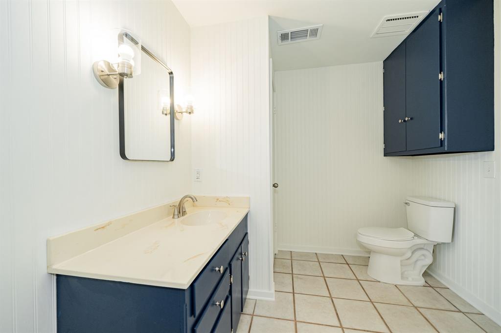 809 Cobb Street Bridgeport, TX 76426 - Photo 31 of 39 a bathroom with a sink a toilet and mirror