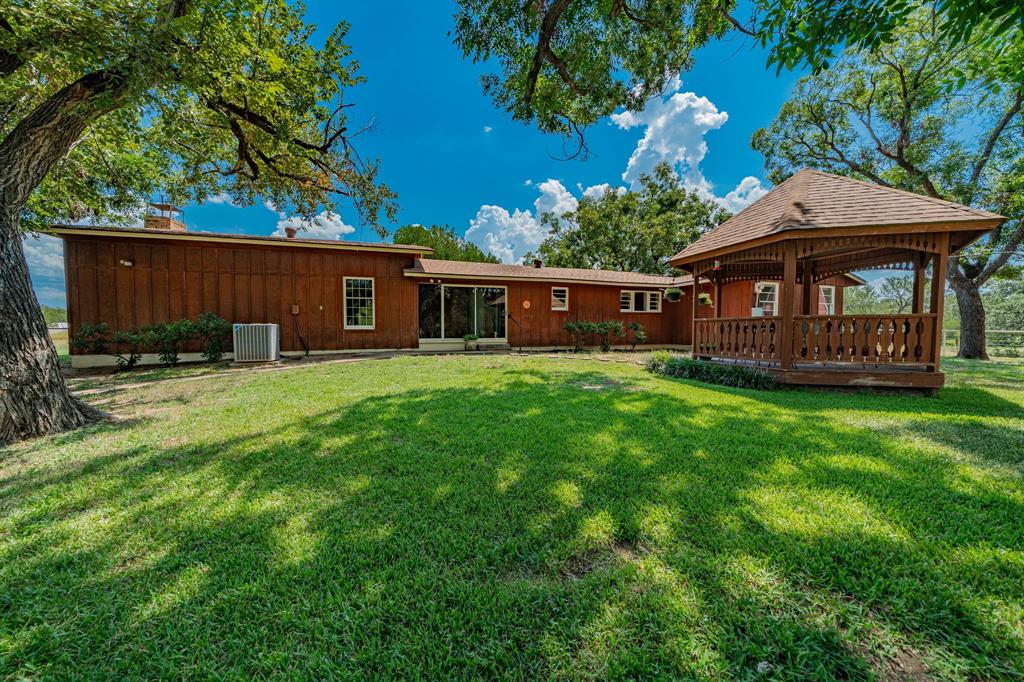 809 Cobb Street Bridgeport, TX 76426 - Photo 32 of 39 a view of a house with a yard and sitting area
