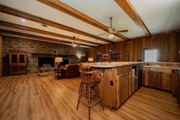 a kitchen with stainless steel appliances granite countertop a stove and a wooden floors