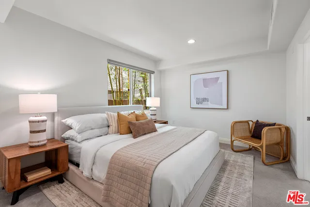 a bedroom with bed and a window