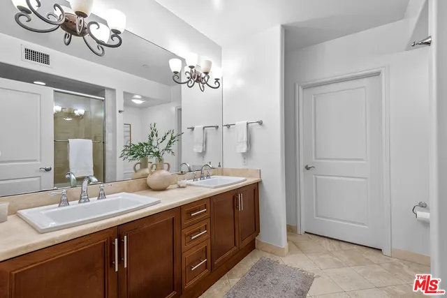 a bathroom with a double vanity sink and a mirror