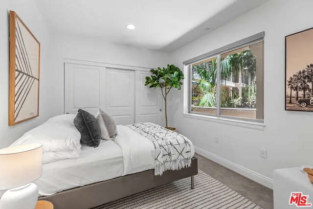 a bedroom with a large bed and a window