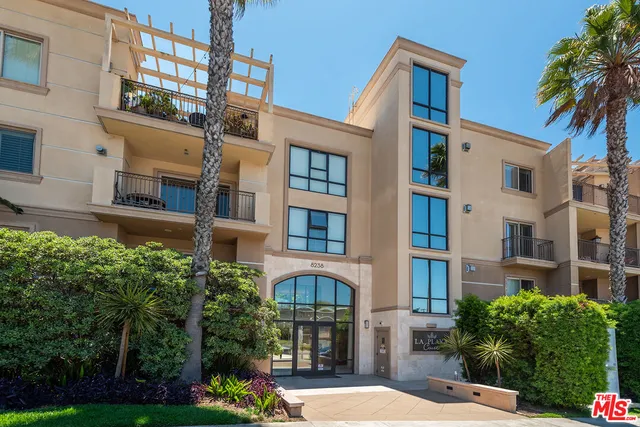 a view of a brick building next to a yard