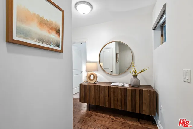 a living room with furniture and a mirror
