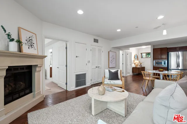 a living room with furniture a fireplace and a table