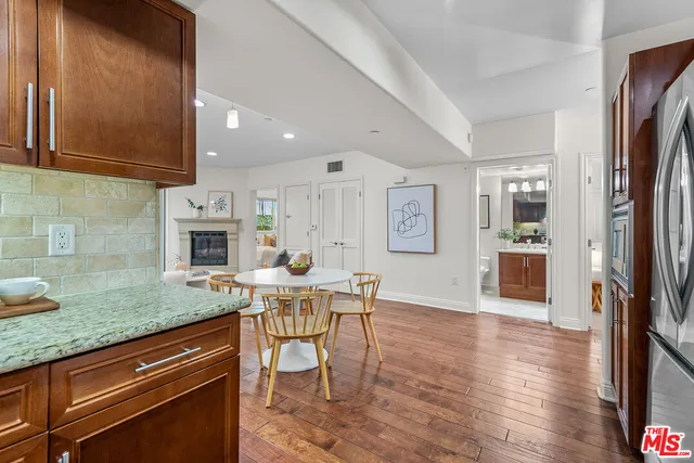 a open kitchen with granite countertop a sink and a stove top oven