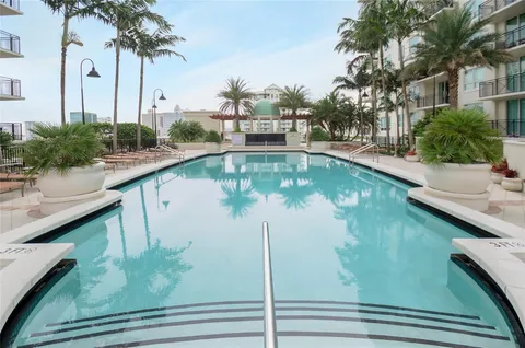 an outdoor space with lots of tables and chairs