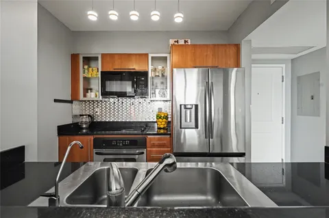 a dining room with furniture potted plants and wooden floor