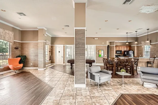 a living room with furniture and floor to ceiling windows