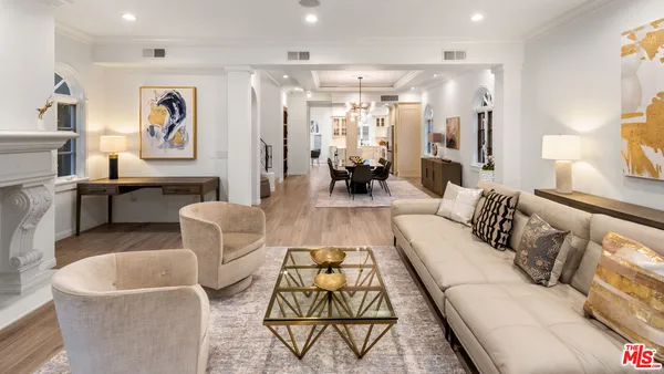 a living room with furniture a fireplace and a table