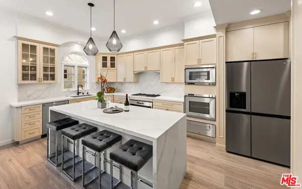 a kitchen with a sink stove top oven and cabinets