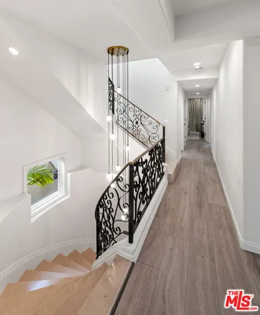 a spacious bedroom with a large bed and a flat screen tv