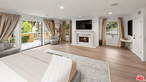 a spacious bedroom with a bed and a large window