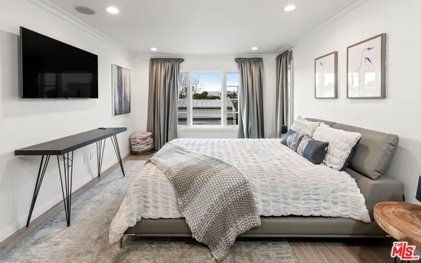 a spacious bedroom with a bed and a chair