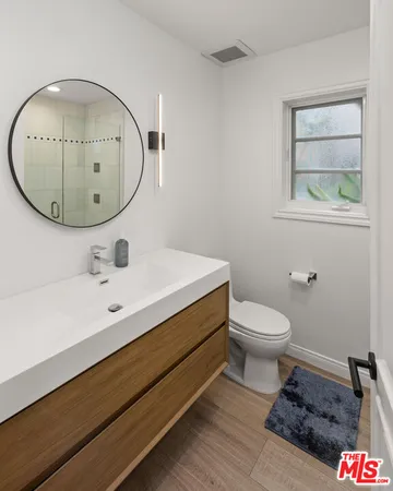 a bedroom with a large bed and a flat tv screen