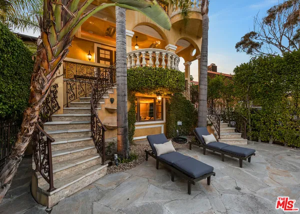 a view of a chairs and table in a patio