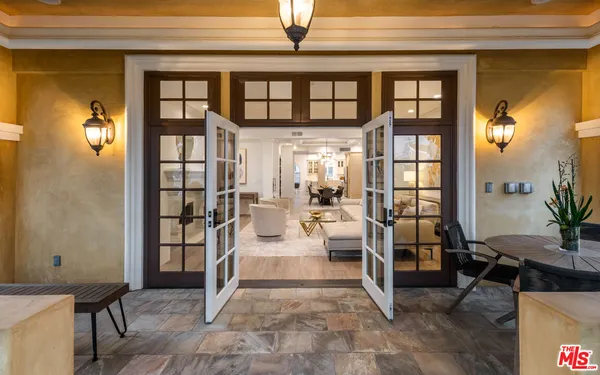 a living room with furniture and a view of kitchen