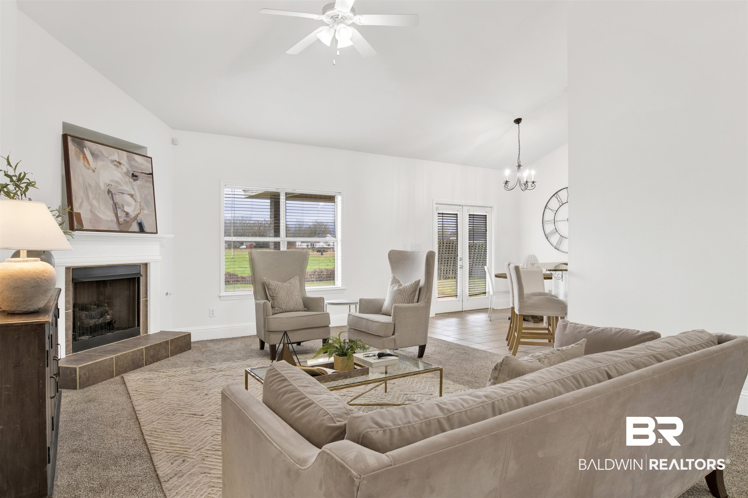 25350 Spindle Lane Daphne, AL 36526 - Photo 6 of 32 Living room featuring ceiling fan with notable chandelier, a fireplace, high vaulted ceiling, and carpet flooring