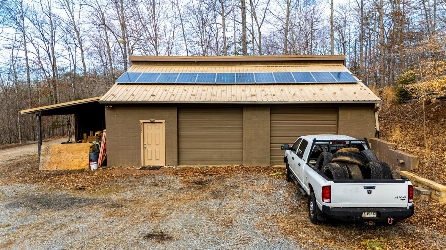 8-lot Cottage Charm Goode, VA 24556 - Photo 15 of 58 a view of a back yard of the house and car parked