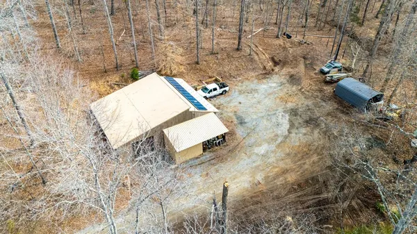 a view of a lush green hillside and houses