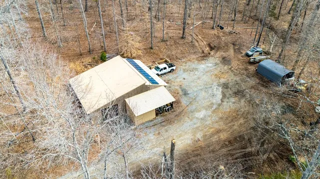 a view of a lush green hillside and houses