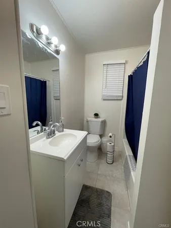 a bathroom with a sink and mirror with toilet