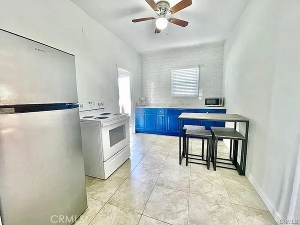 a kitchen with stainless steel appliances cabinets and a window