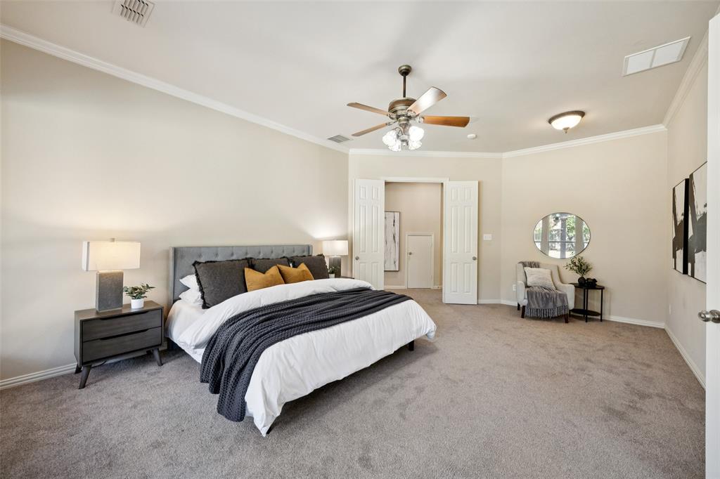 511 Mockingbird Drive Murphy, TX 75094 - Photo 16 of 37 a spacious bedroom with a bed a chandelier and a couch