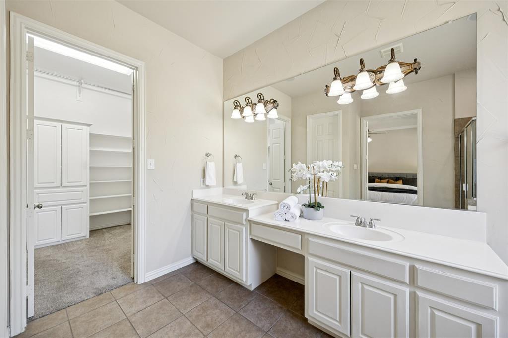 511 Mockingbird Drive Murphy, TX 75094 - Photo 18 of 37 a bathroom with a double vanity sink and a mirror