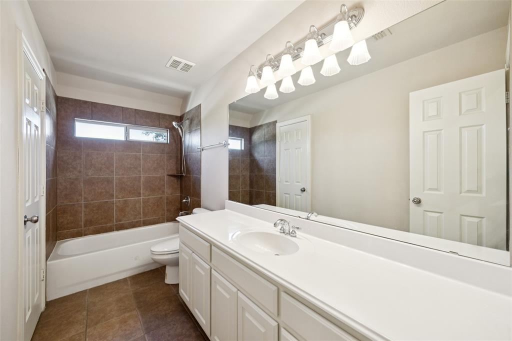 511 Mockingbird Drive Murphy, TX 75094 - Photo 24 of 37 a bathroom with a bathtub shower sink mirror and a bathtub