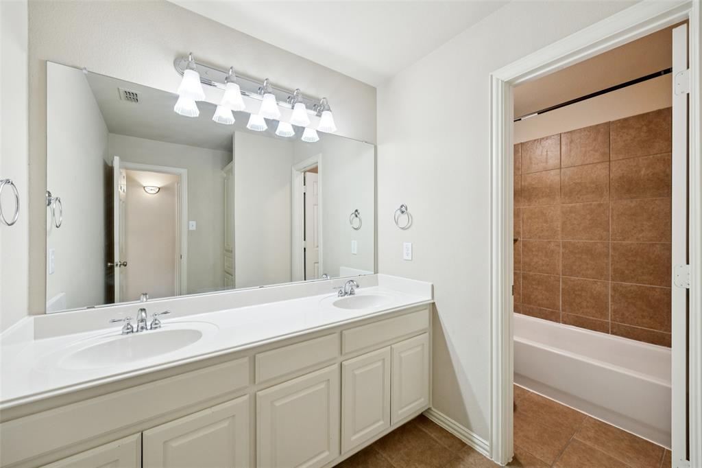 511 Mockingbird Drive Murphy, TX 75094 - Photo 27 of 37 a bathroom with a double vanity sink mirror and shower