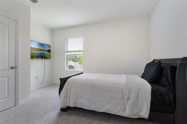 a bedroom with a bed and window