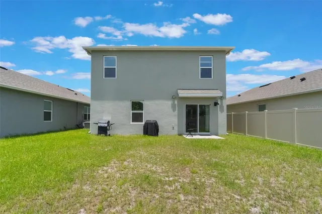 a view of a house with a yard and a garage